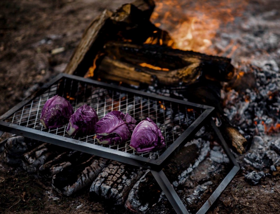 Barebones Fire Pit Grill Grate grilling food over an open fire