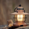 Barebones Edison Mini Lantern Copper lit up at a campsite